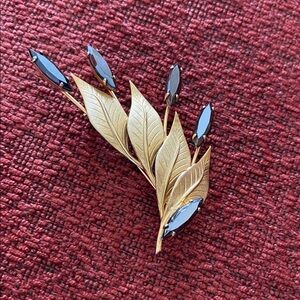 Elegant Gold and Black Leaf Brooch